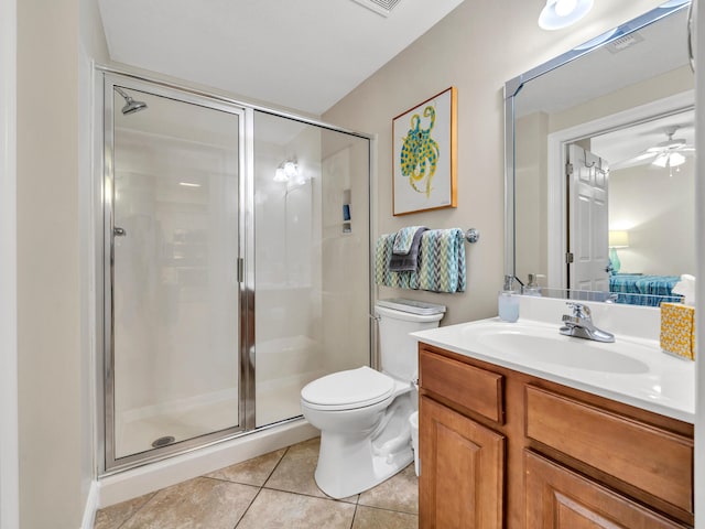 bathroom featuring ceiling fan, tile patterned flooring, toilet, a shower with door, and vanity