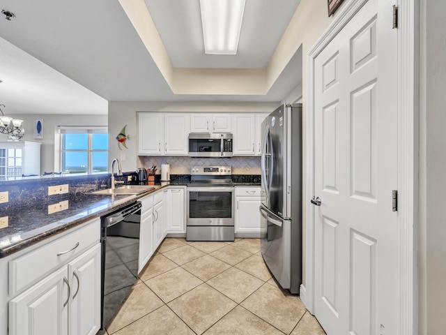 kitchen with white cabinets, sink, light tile patterned floors, appliances with stainless steel finishes, and tasteful backsplash