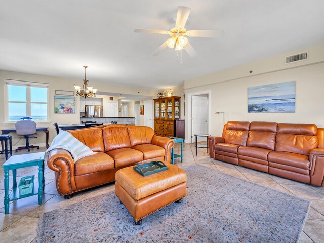 living room featuring ceiling fan with notable chandelier and light tile patterned flooring