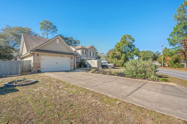 view of front of home with a front yard and a garage