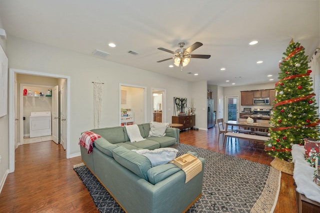 living room with ceiling fan, washer / dryer, and dark wood-type flooring