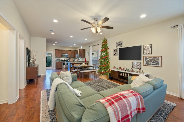 living room featuring dark hardwood / wood-style floors and ceiling fan