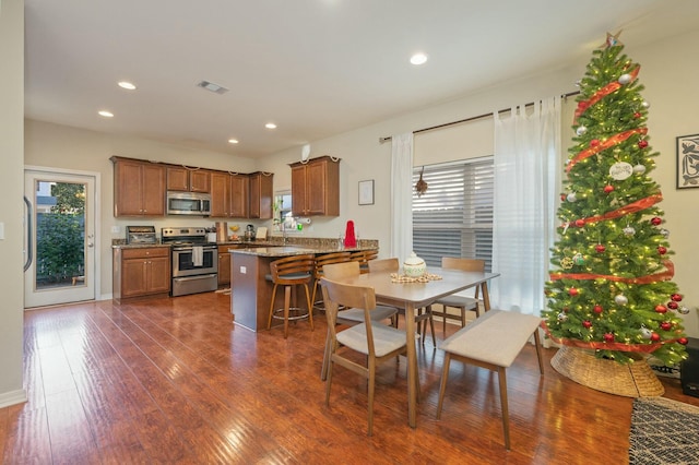 dining area featuring dark wood-type flooring