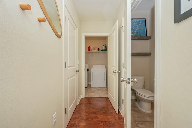 hallway with washing machine and dryer and dark wood-type flooring