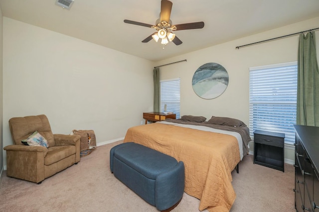 bedroom featuring ceiling fan and light carpet