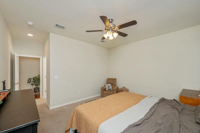 bedroom with ceiling fan and light carpet