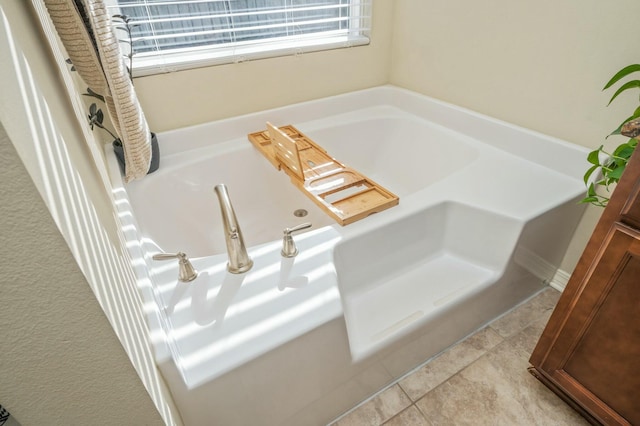 bathroom with tile patterned flooring and a tub to relax in