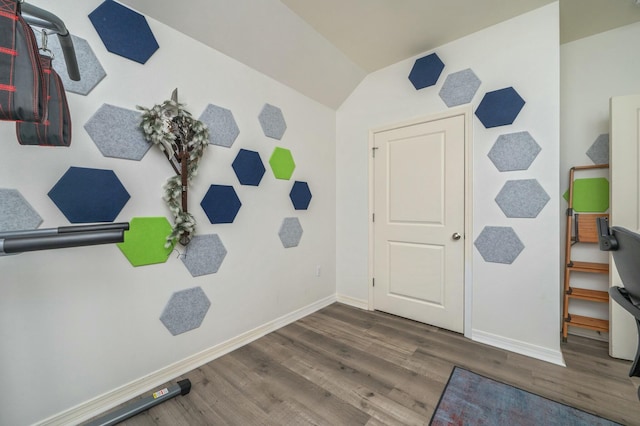 interior space with dark hardwood / wood-style flooring and vaulted ceiling