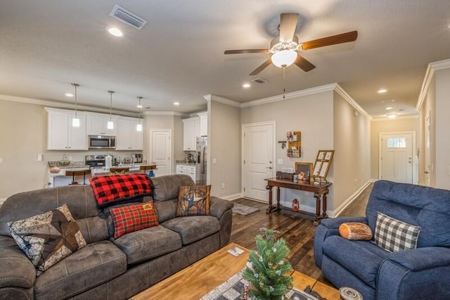 living room featuring dark hardwood / wood-style floors, ceiling fan, and crown molding