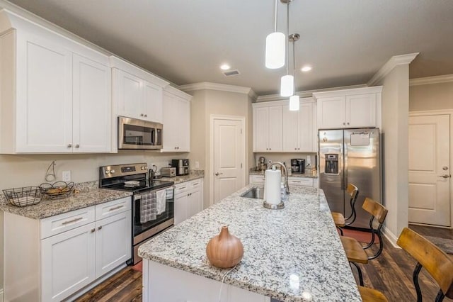 kitchen featuring pendant lighting, sink, appliances with stainless steel finishes, dark hardwood / wood-style flooring, and white cabinetry