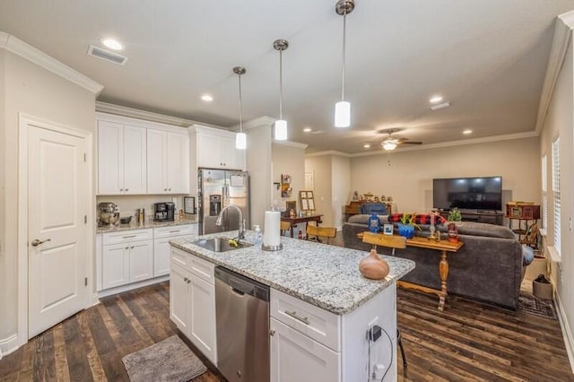 kitchen with hanging light fixtures, white cabinetry, sink, and stainless steel appliances