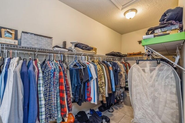 walk in closet with light tile patterned floors