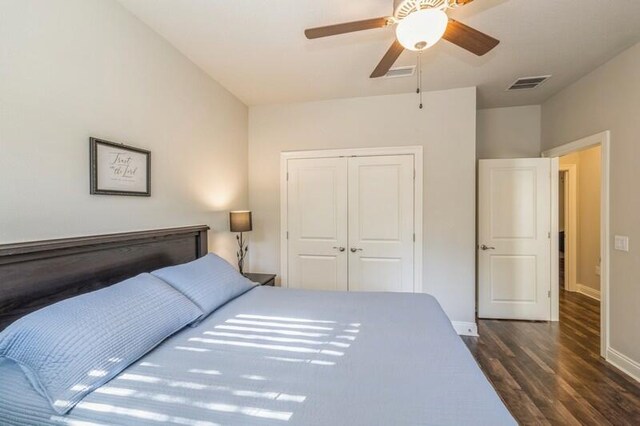 bedroom with a closet, ceiling fan, and dark wood-type flooring