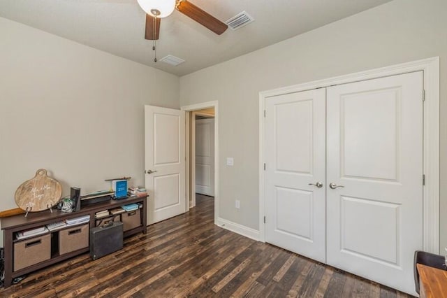 bedroom featuring dark hardwood / wood-style flooring, a closet, and ceiling fan