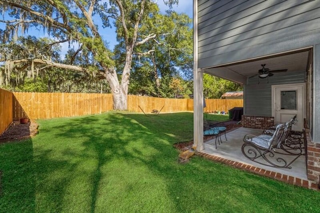 view of yard featuring a patio area and ceiling fan