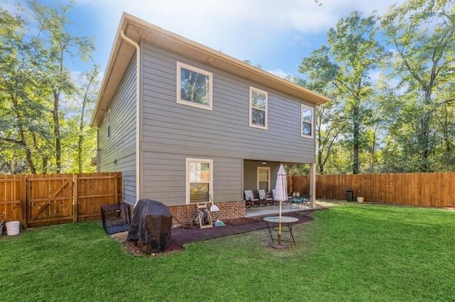 rear view of house with a patio area and a yard