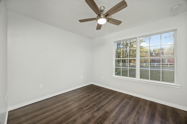 spare room featuring ceiling fan, dark hardwood / wood-style flooring, and a textured ceiling