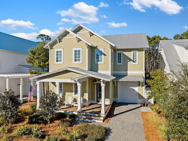 view of front of home featuring a porch and a garage