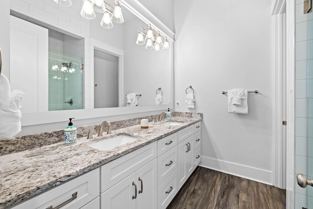 bathroom featuring hardwood / wood-style floors, vanity, and walk in shower