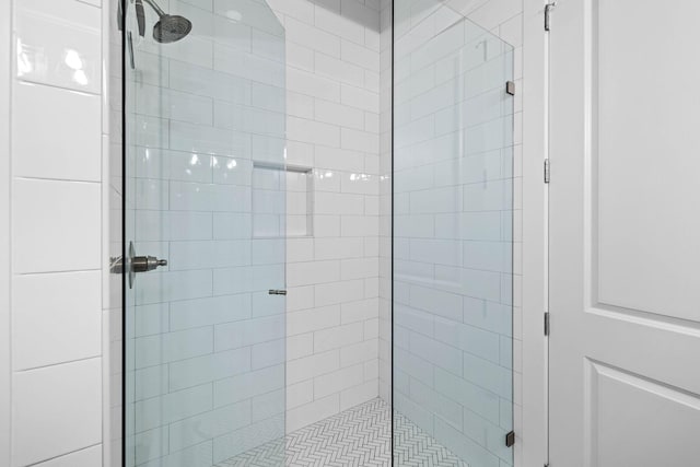 bathroom with a shower with door