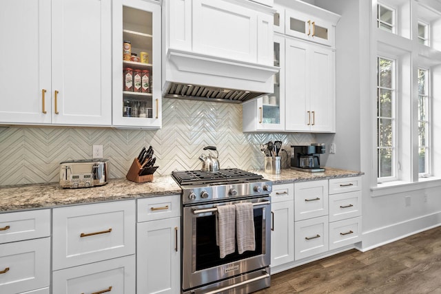 kitchen featuring white cabinets, dark hardwood / wood-style flooring, stainless steel stove, and light stone countertops