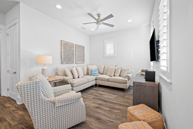 living room featuring ceiling fan and dark hardwood / wood-style floors