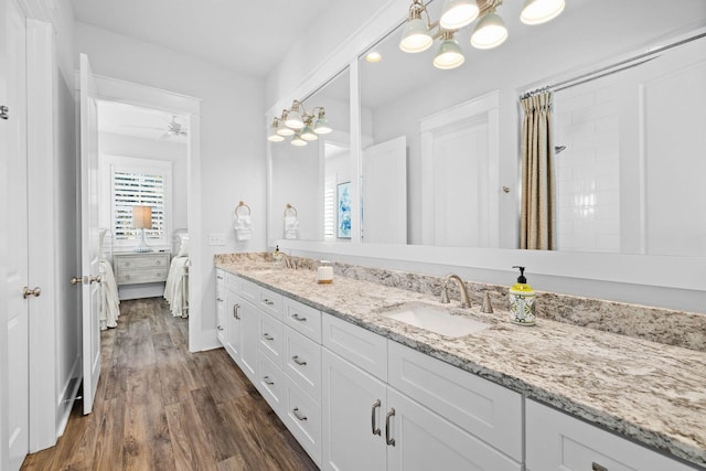 bathroom featuring hardwood / wood-style flooring, ceiling fan, and vanity