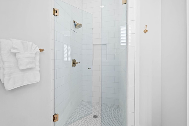 bathroom featuring a shower with door