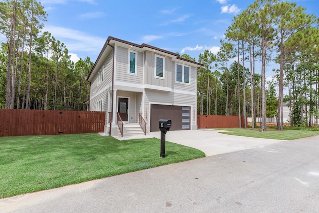 view of front of property with a front lawn and a garage