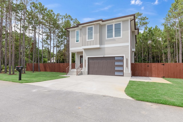 view of front of home with a front yard and a garage