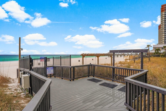 deck featuring a water view and a view of the beach