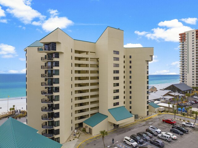 9850 S Thomas Dr Unit 1004W, Panama City Beach, FL 32408 - view of apartment building / complex with a water view and uncovered parking