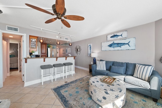 9850 S Thomas Dr Unit 1004W, Panama City Beach, FL 32408 - living room featuring rail lighting, ceiling fan, and light tile patterned flooring