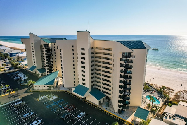 view of property featuring a beach view and a water view