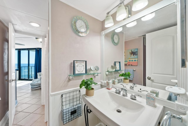 bathroom with tile patterned flooring, vanity, and crown molding