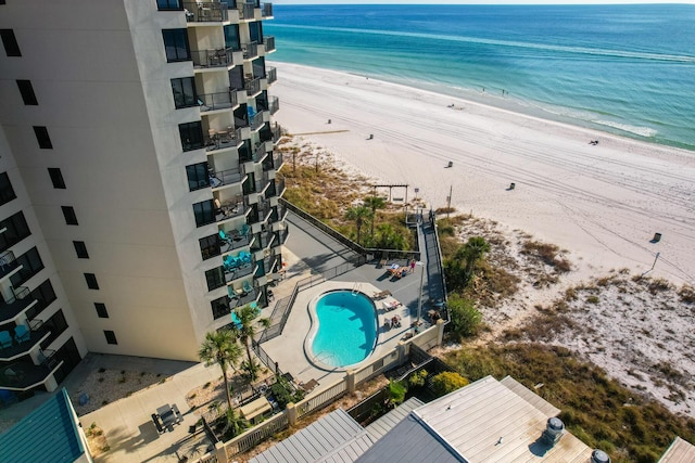 bird's eye view with a water view and a beach view