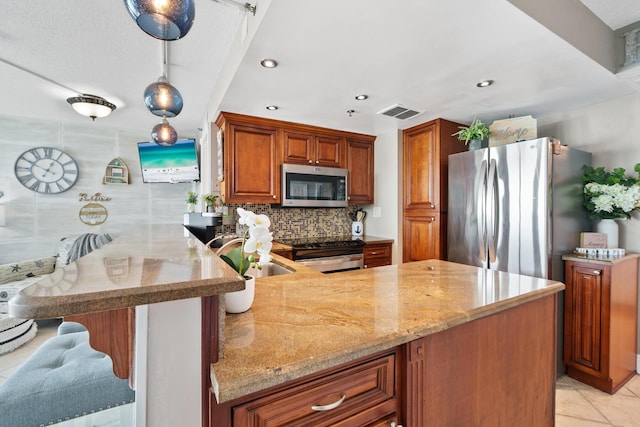 kitchen with kitchen peninsula, backsplash, stainless steel appliances, sink, and decorative light fixtures