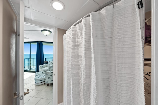 9850 S Thomas Dr Unit 1004W, Panama City Beach, FL 32408 - hall featuring expansive windows, a water view, and tile patterned floors