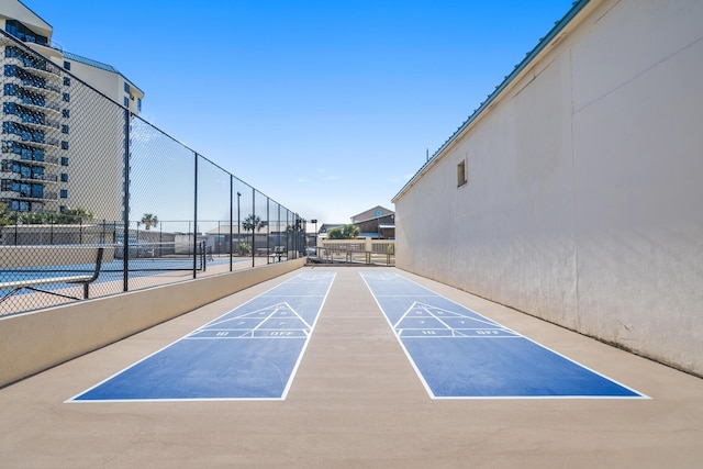 view of property's community with tennis court