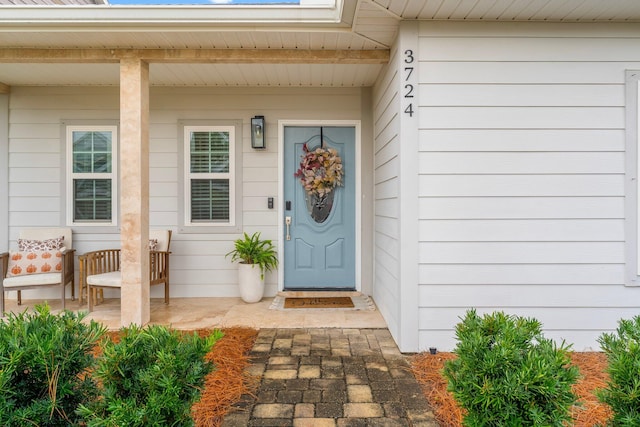 doorway to property with covered porch