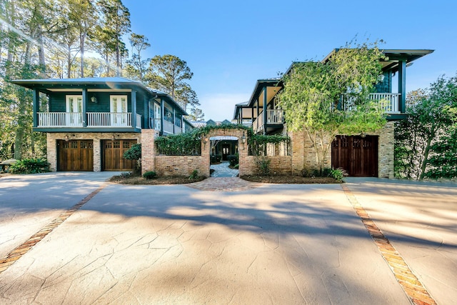 view of front of home featuring a balcony and a garage