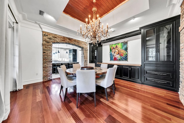 dining space with a chandelier, ornamental molding, wooden ceiling, and hardwood / wood-style flooring