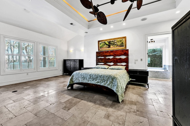 bedroom featuring ceiling fan, ornamental molding, and a tray ceiling