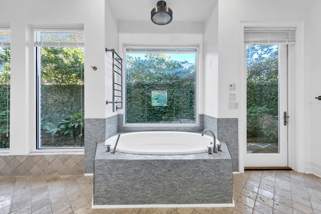 bathroom featuring tiled tub