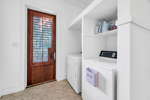 washroom featuring light tile patterned floors and washing machine and clothes dryer