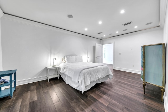 bedroom with dark hardwood / wood-style floors and crown molding