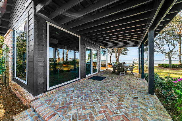 view of patio with a water view