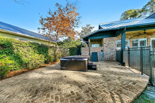 view of patio / terrace featuring ceiling fan, central AC unit, and a hot tub