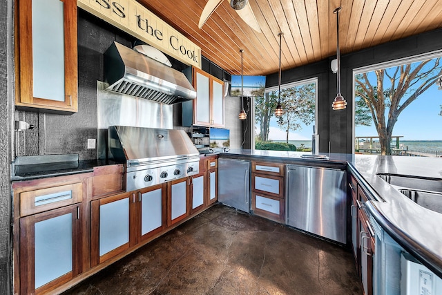 view of patio / terrace with area for grilling, a water view, and an outdoor kitchen