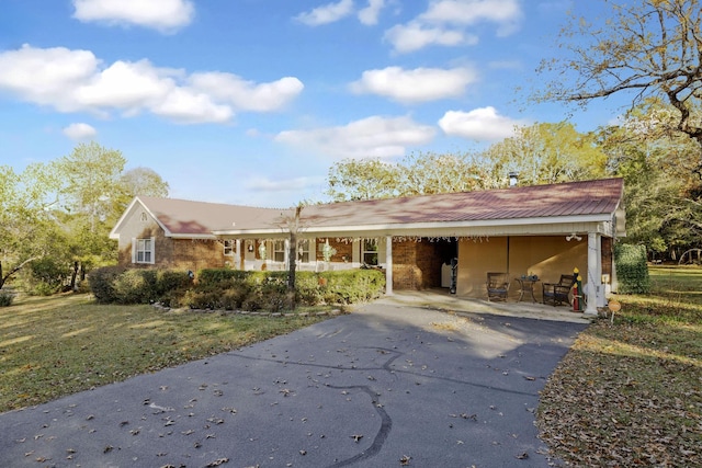 ranch-style house with a carport and a front yard